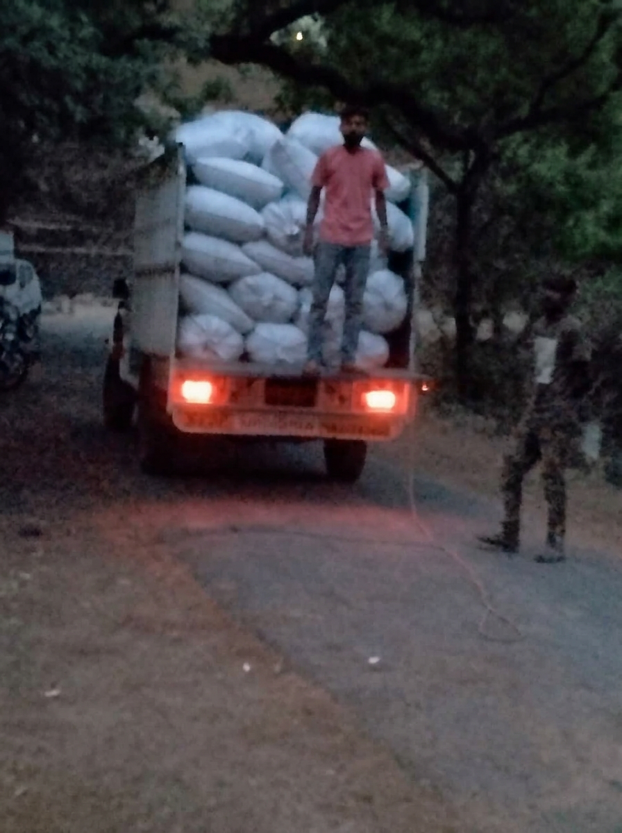 Bagged material being transported by truck at dusk
